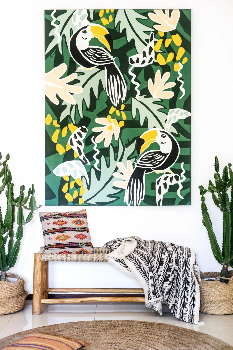 bold artwork on a white wall, modern furniture with plants