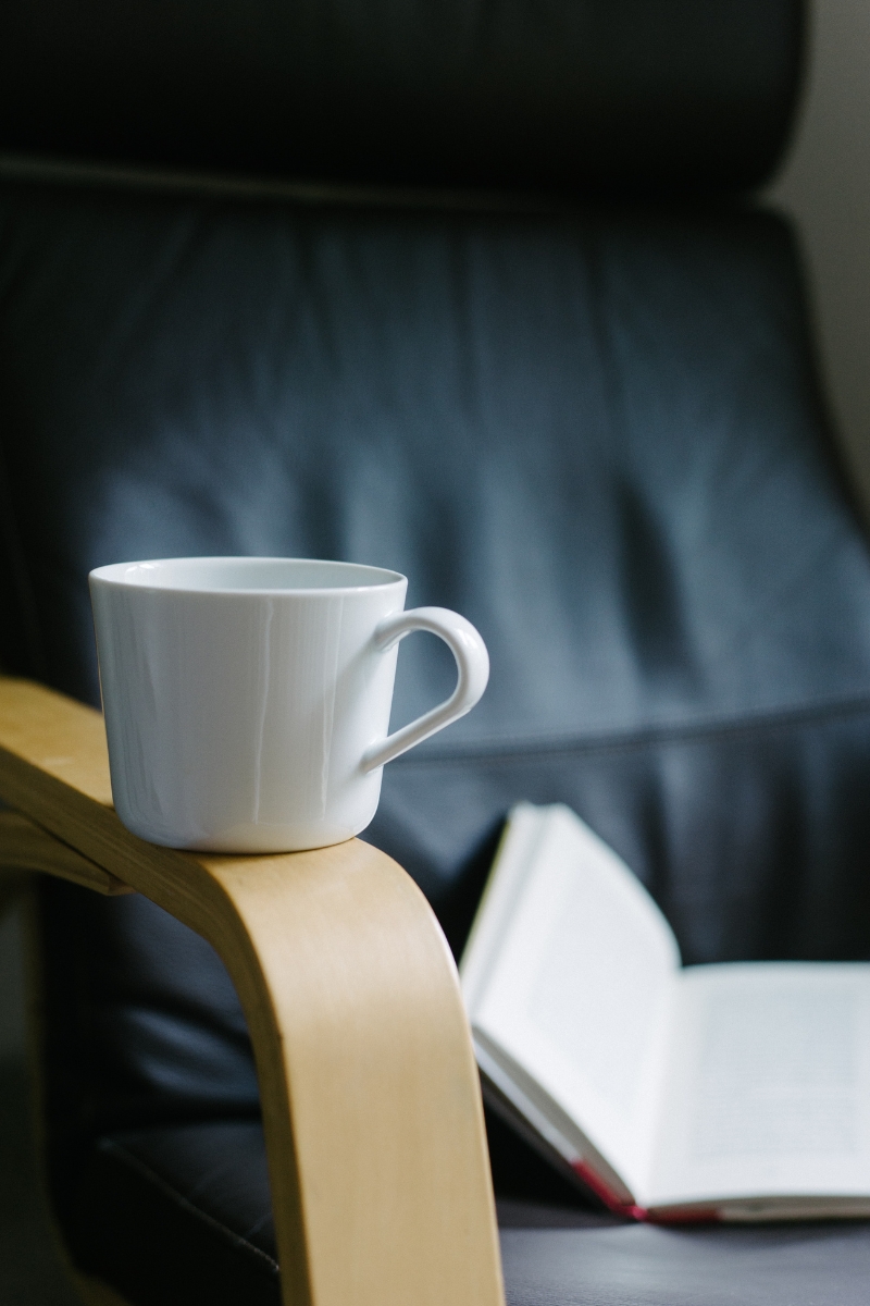 coffee mug and an open book