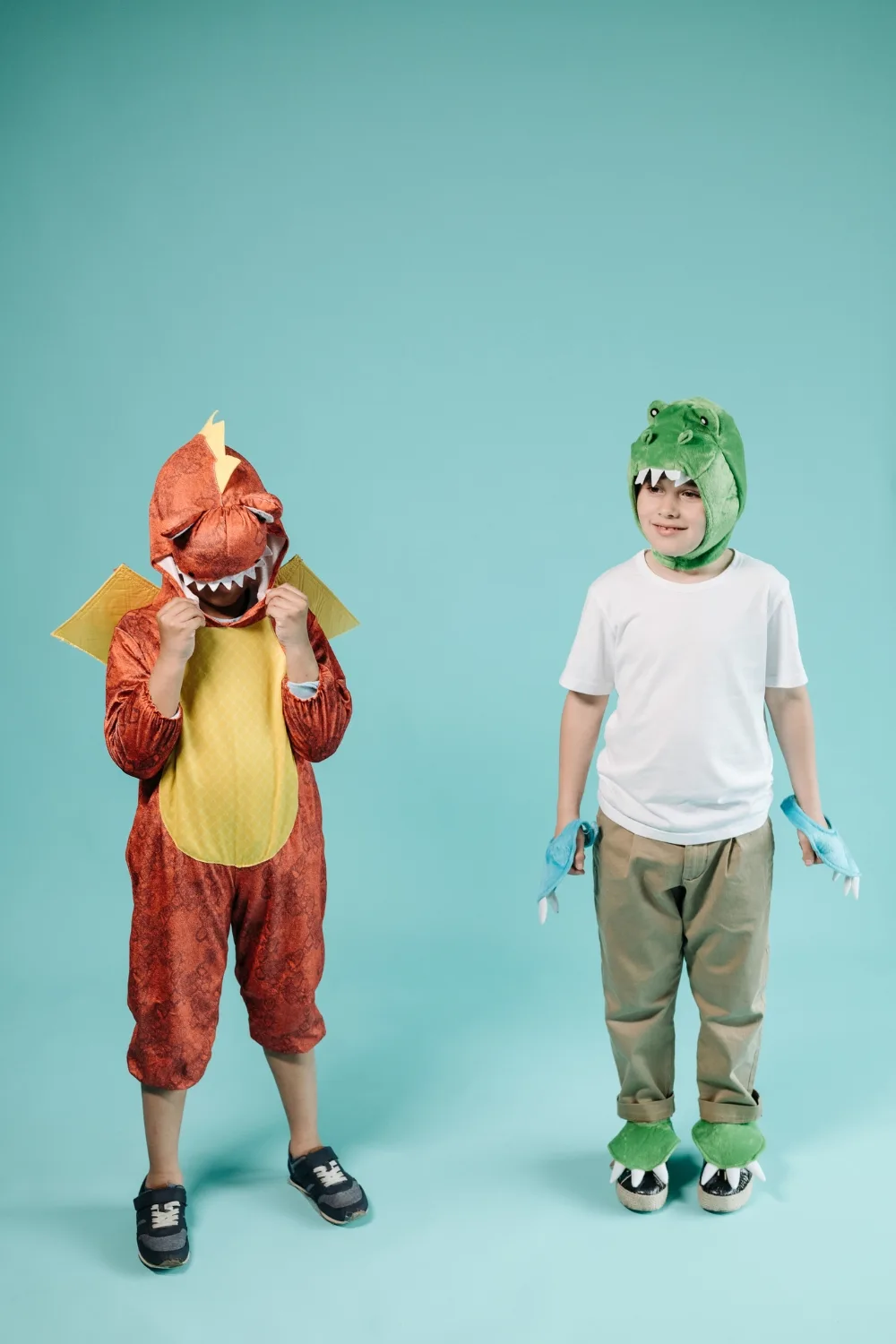 two children wearing dinosaur costumes