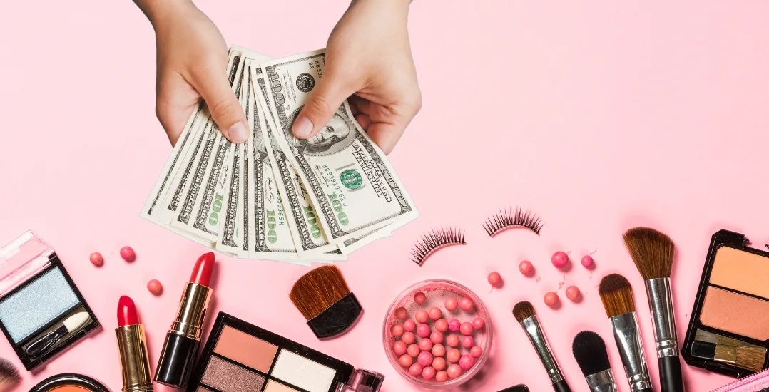 hands holding money and lots of cosmetics