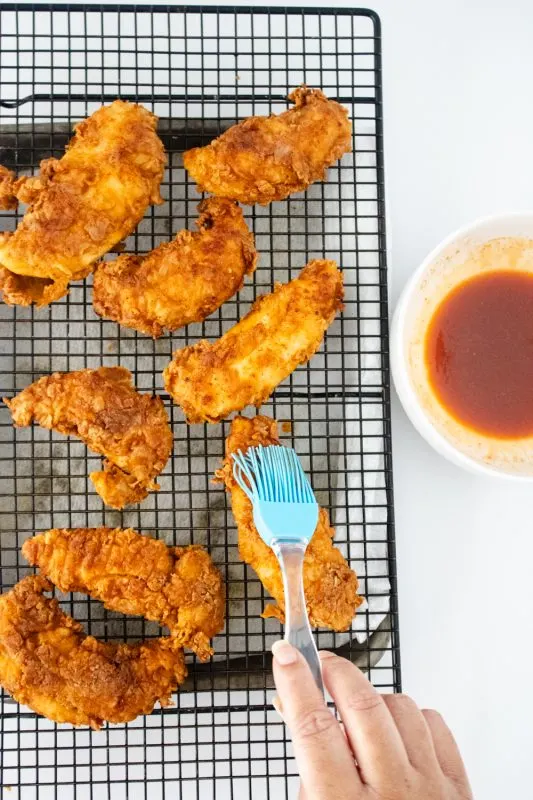 applying glaze to fried chicken tenders