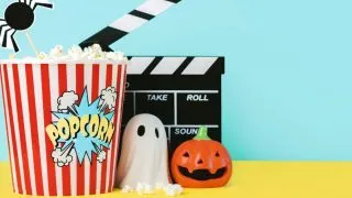 a blue wall and yellow table with a bucket of movie popcorn (says 