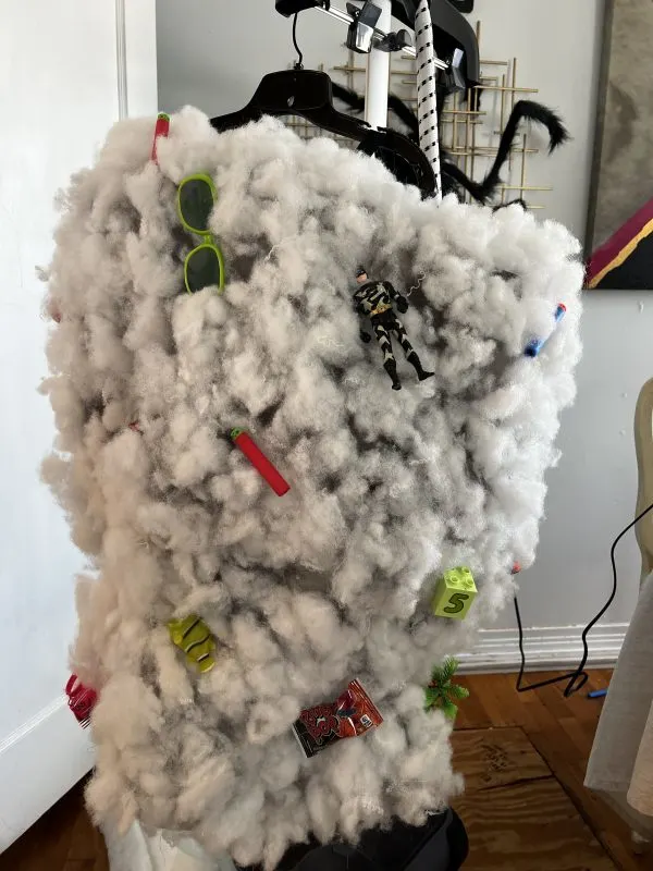 a tornado costume featuring poly fill clouds and toy/candy debris