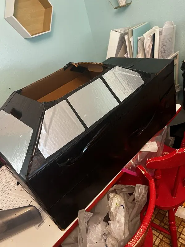 black cardboard box turned into a car costume